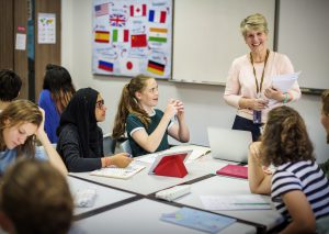 group-of-diverse-high-school-students-studying-in-class-with-female-teacher