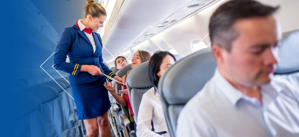Stewardess talking to passengers on plane.