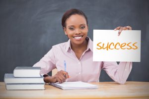 young teacher holding a Success sign