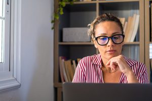 woman deep in thought on a laptop