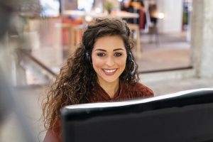 a professional woman sitting at computer, customer service