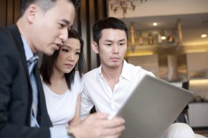 insurance agent talking to a young couple
